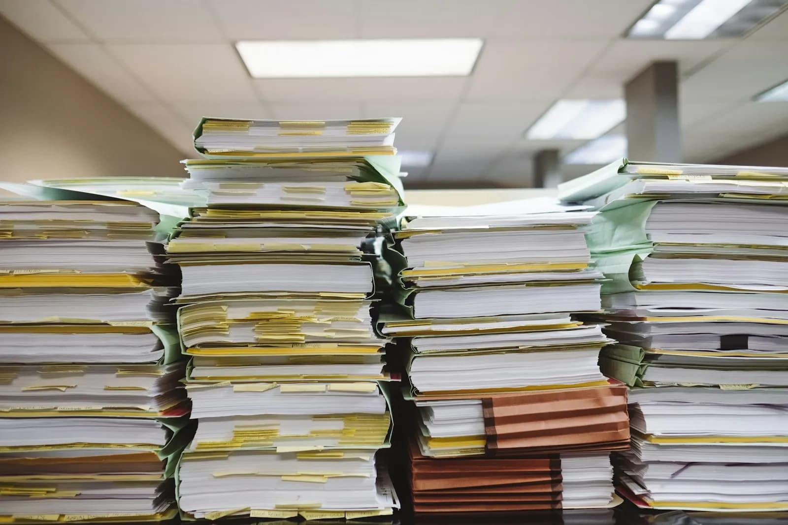 Pilas de documentos y carpetas con marcadores en una oficina